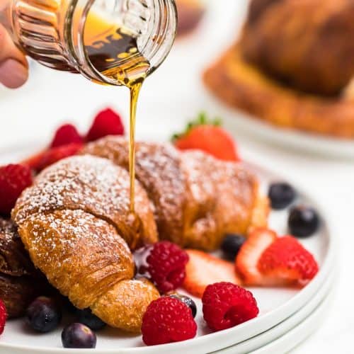 Drizzling maple syrup over the Croissant French Toast.