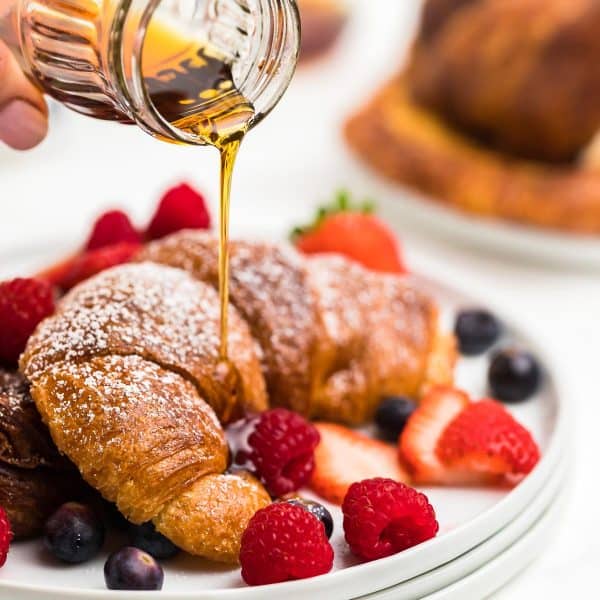 Drizzling maple syrup over the Croissant French Toast.