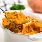 A spoonful of freshly made mashed sweet potatoes.