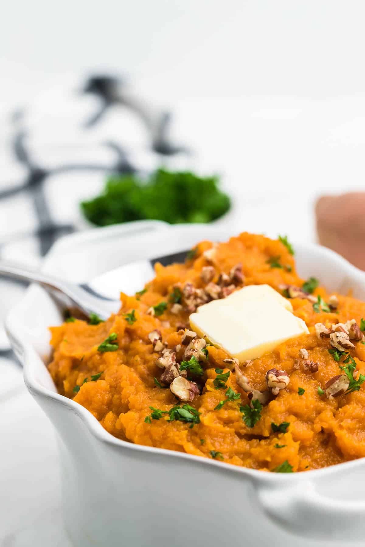 closeup of mashed sweet potatoes served in a white bowl