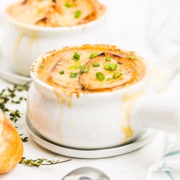 Closeup of a French Onion Soup in a white bowl.