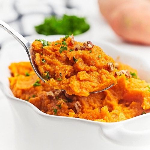 Closeup of a serving bowl of Mashed Sweet Potatoes.