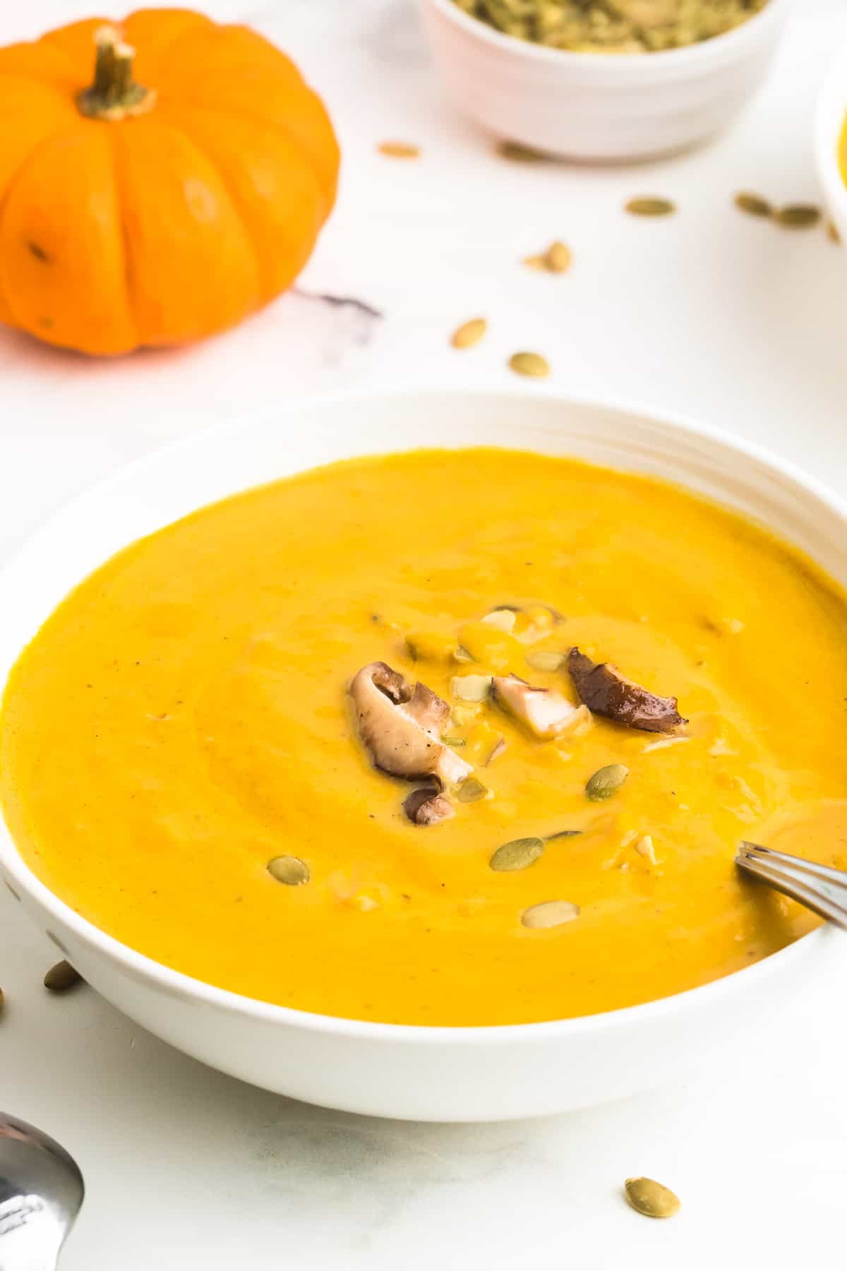 Homemade Pumpkin Soup made with canned pumpkins served in a white bowl.