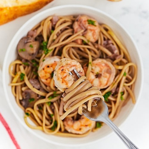 Shrimp and Mushroom Pasta in a white bowl.