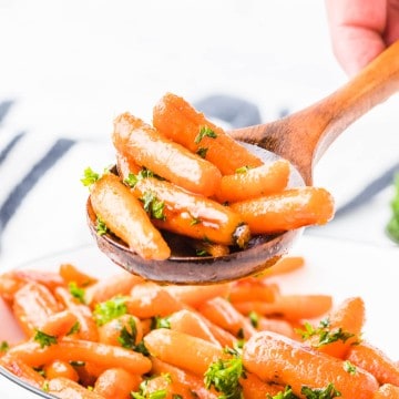A spoonful of hot glazed. candied carrots