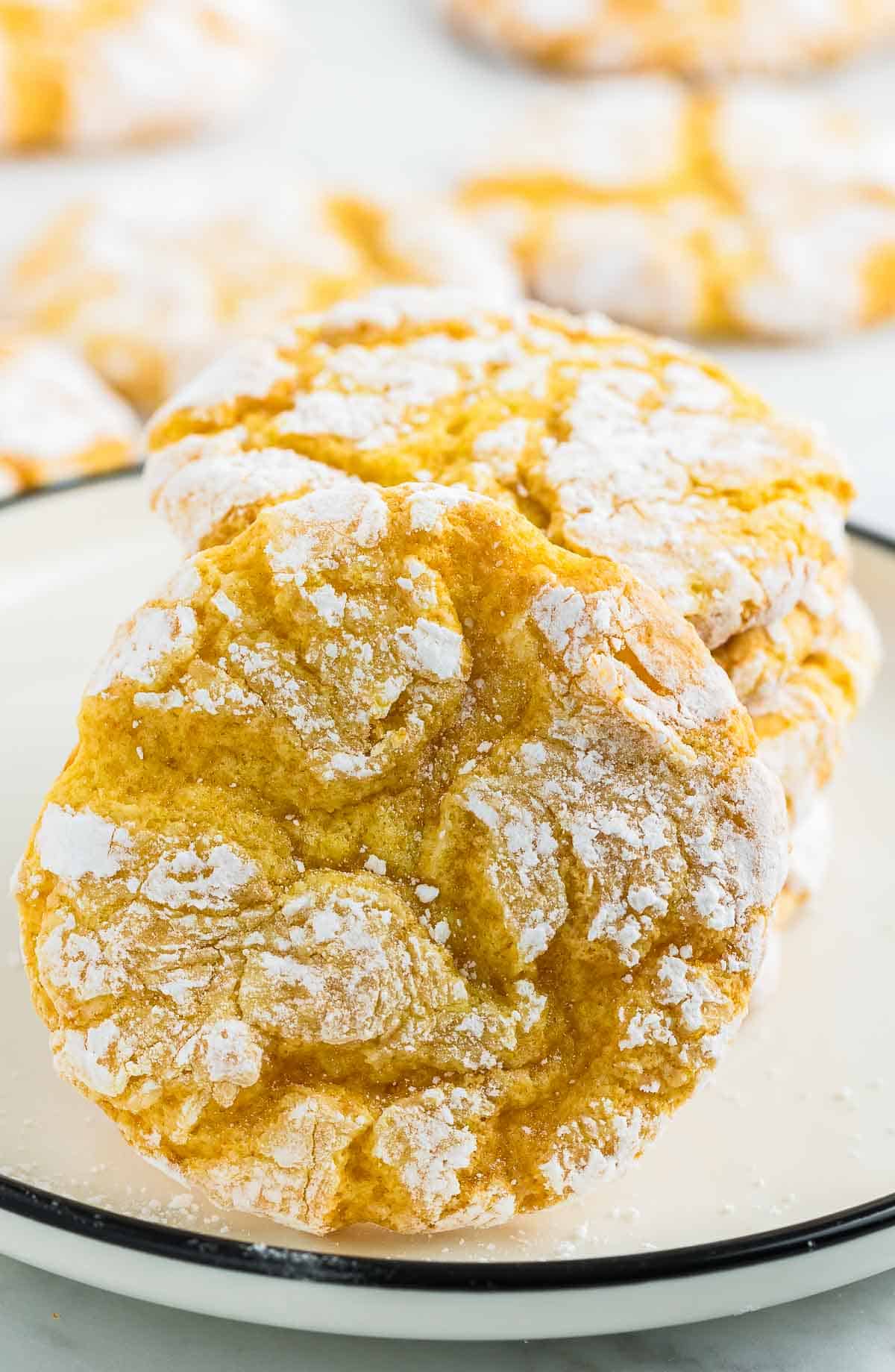 Closeup of Lemon Crinkle Cookies on a white plate.
