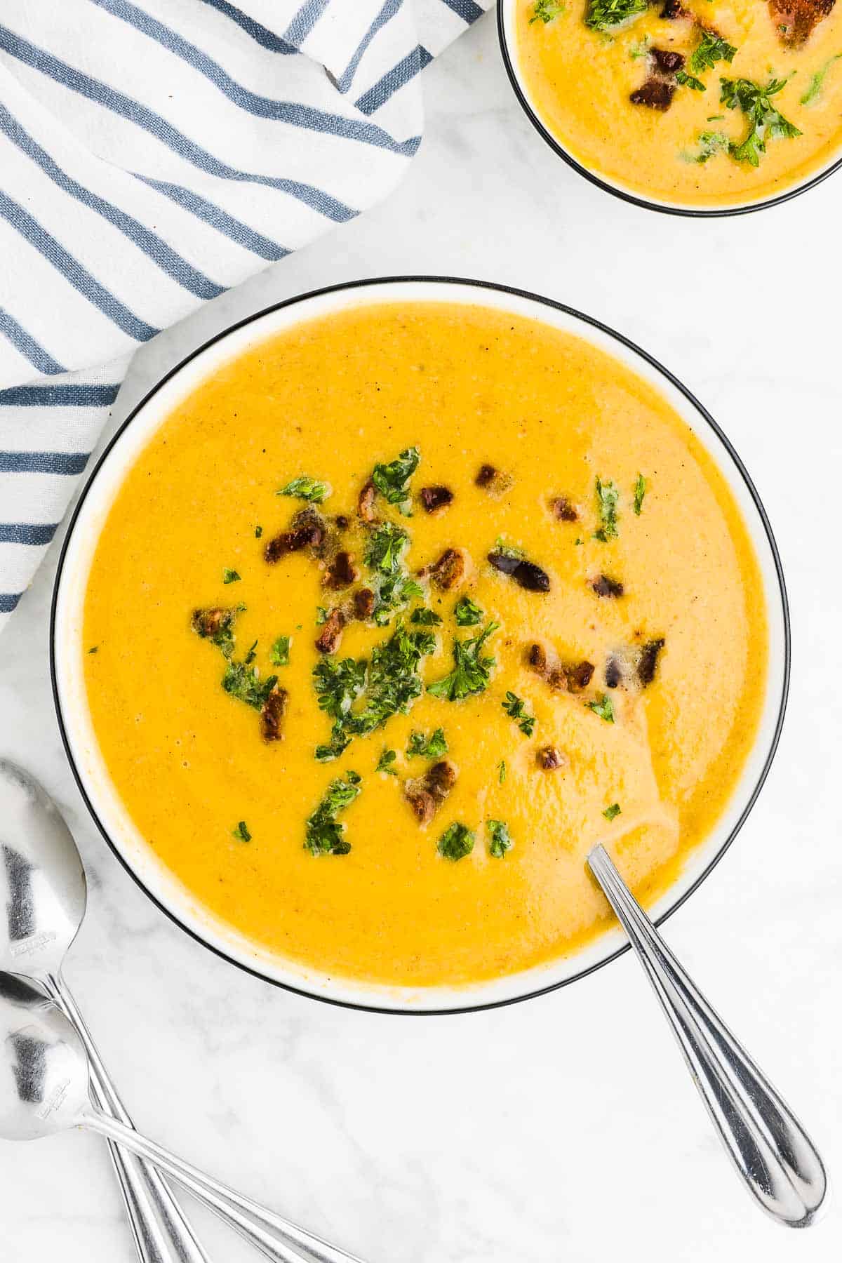 Butternut Squash Soup in a bowl with a spoon.