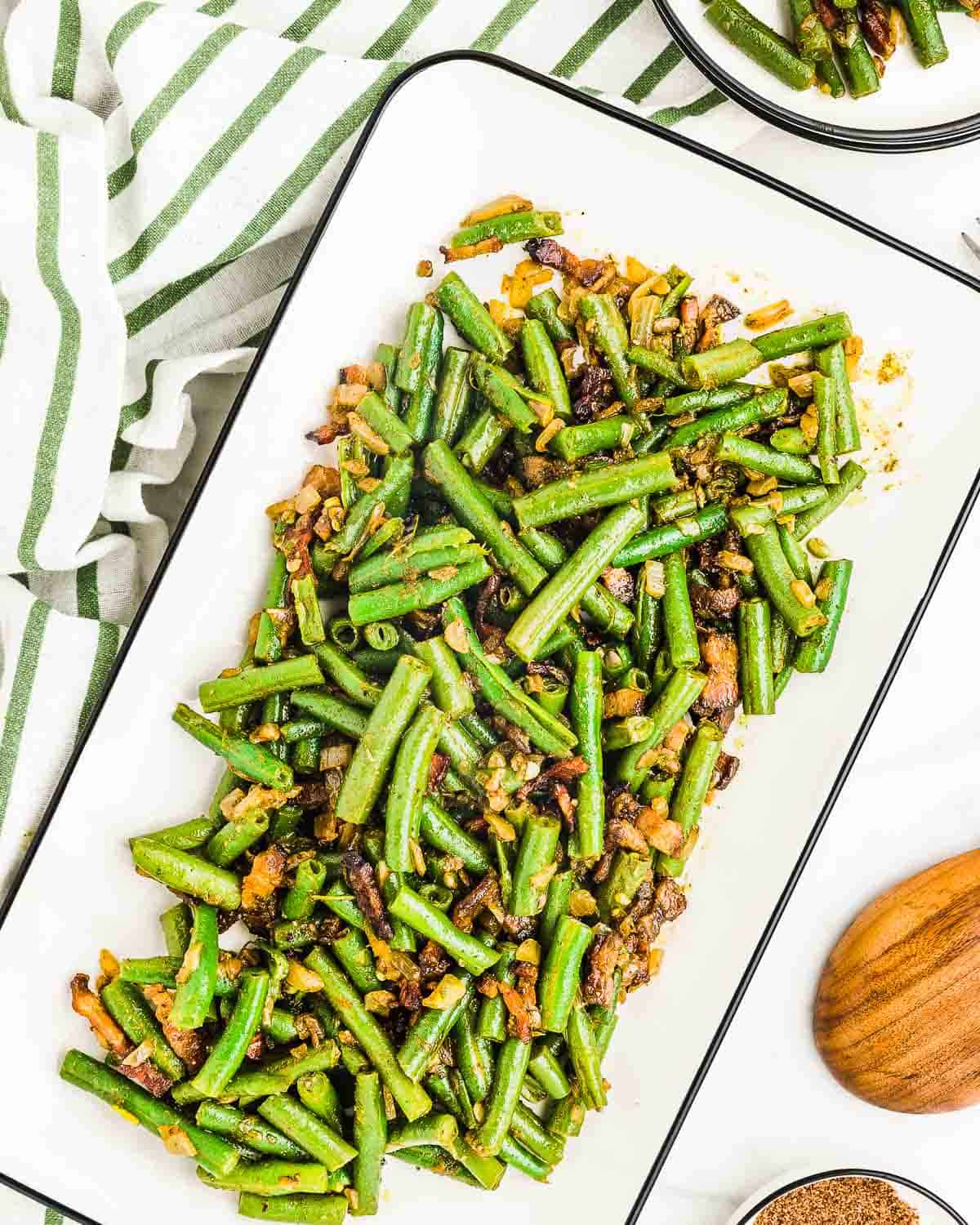 Green Beans with Bacon and Onions on a rectangular serving plate.