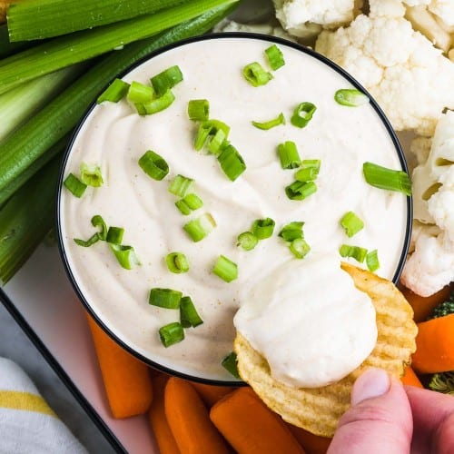 Dipping a chip into a bowl of Curry Dip.