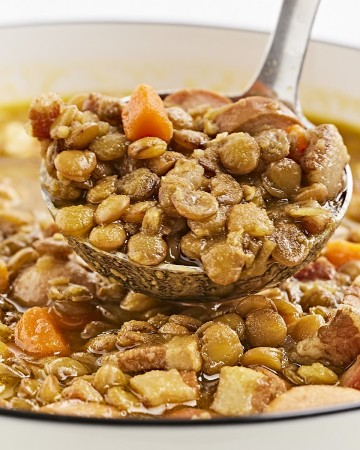 A spoonful of lentil soup with sausage.