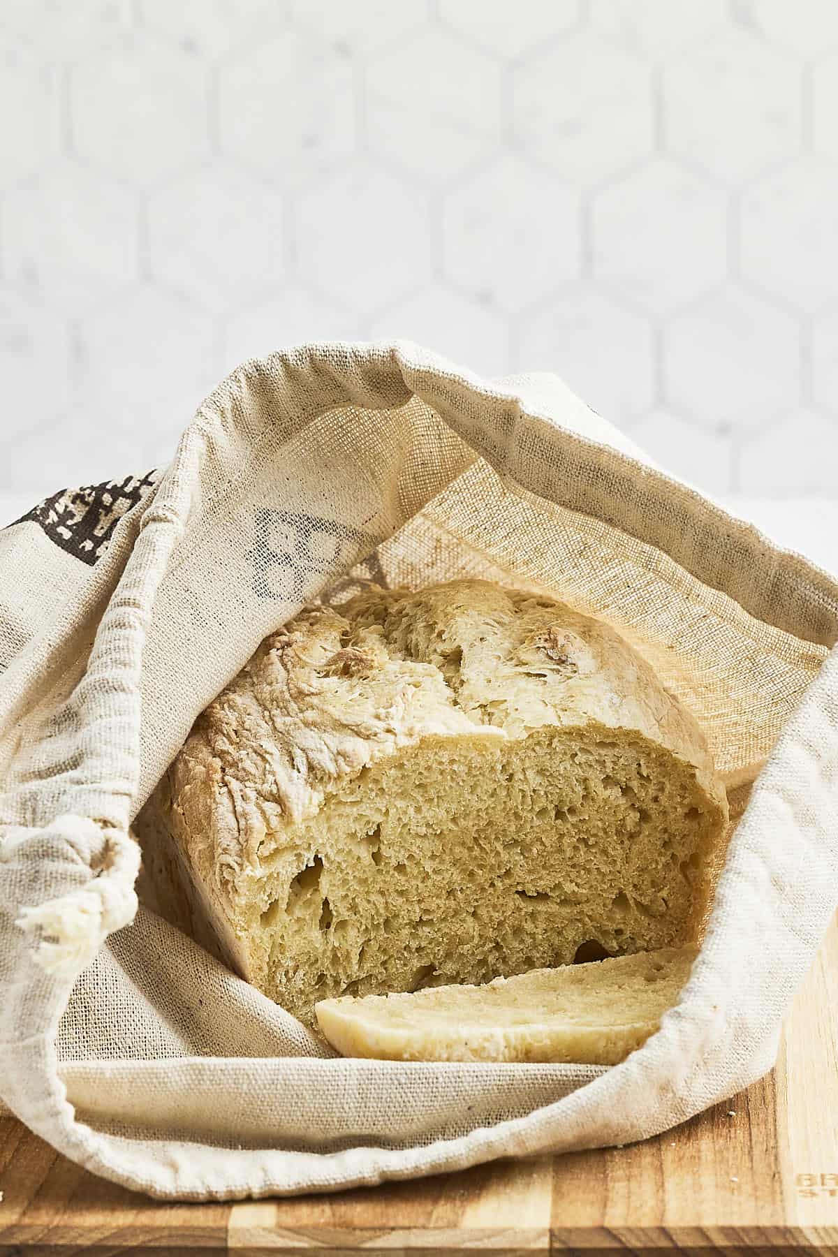 Storing the freshly baked bread in a canvas bread bag. 
