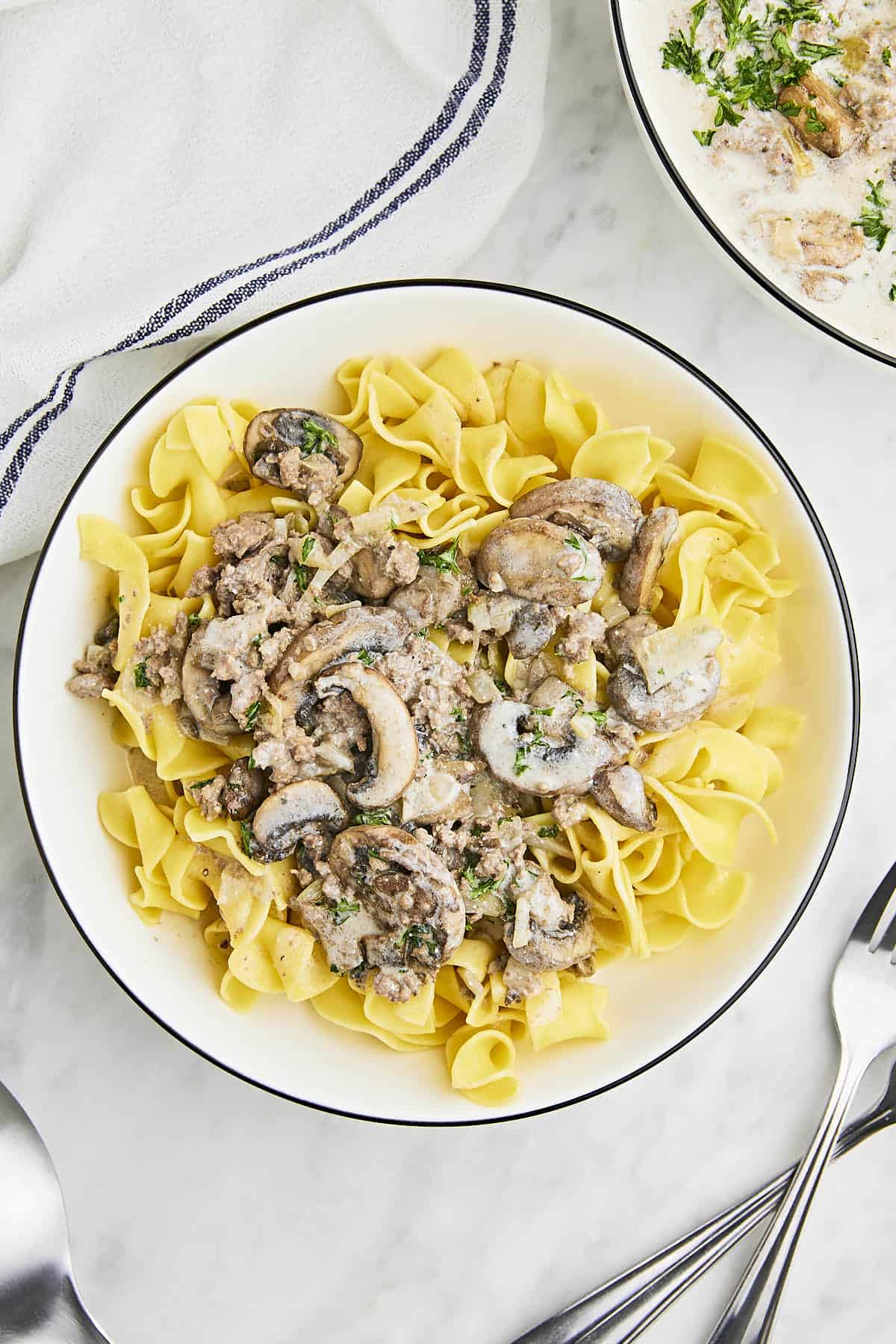 Ground Beef Stroganoff served over tender egg noodles and garnished with parsely.