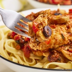 A fork holding freshly cooked Chicken Cacciatore.