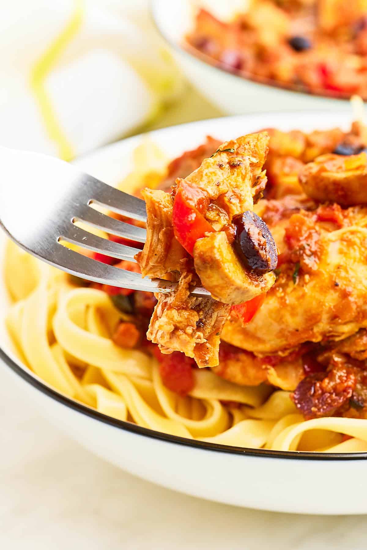 A fork holding freshly cooked Chicken Cacciatore.
