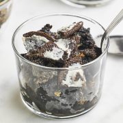 Oreo Dump Cake served in a glass jar with a spoon.