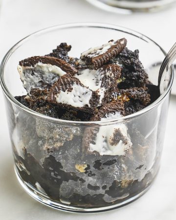 Oreo Dump Cake served in a glass jar with a spoon.