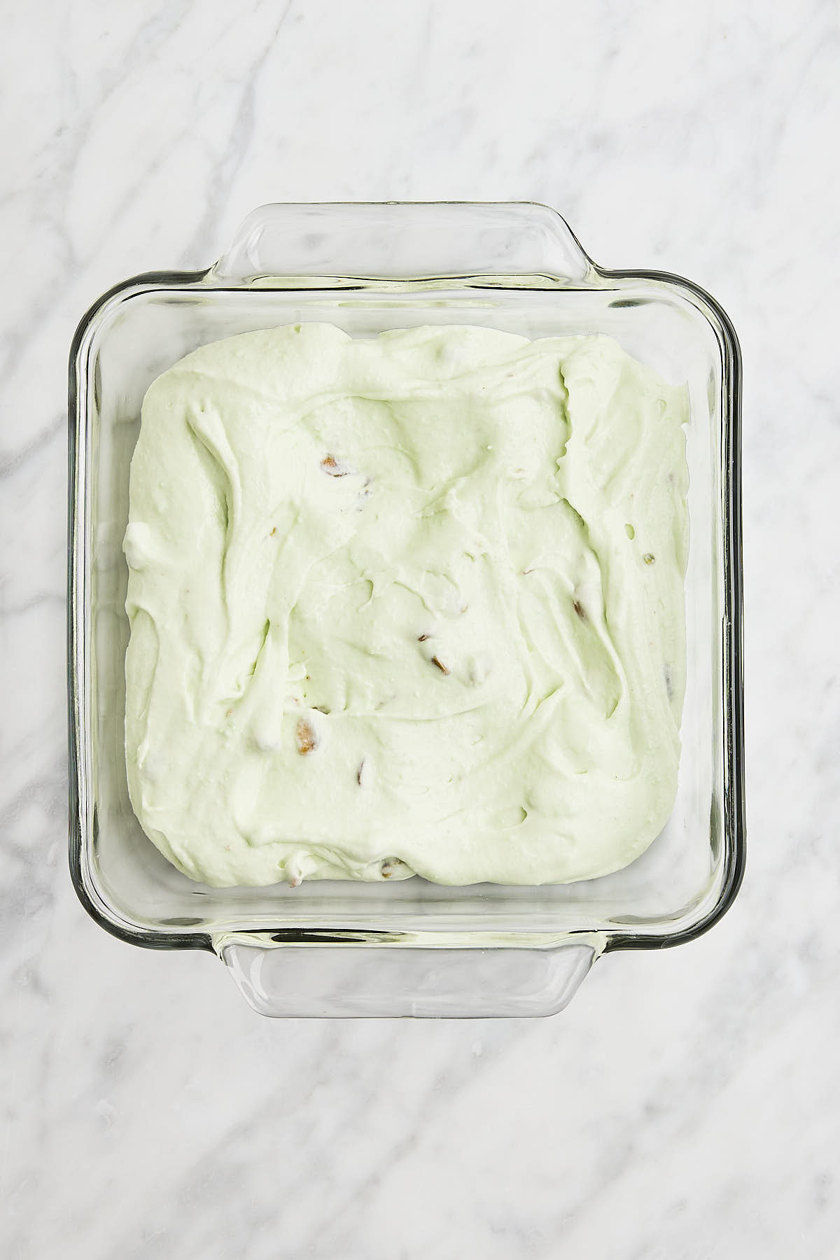 Pistachio Ice Cream in a 9x9 dish before being stored in the freezer.