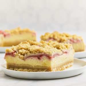 Closeup of a Strawberry Cheesecake Bar on a white plate.