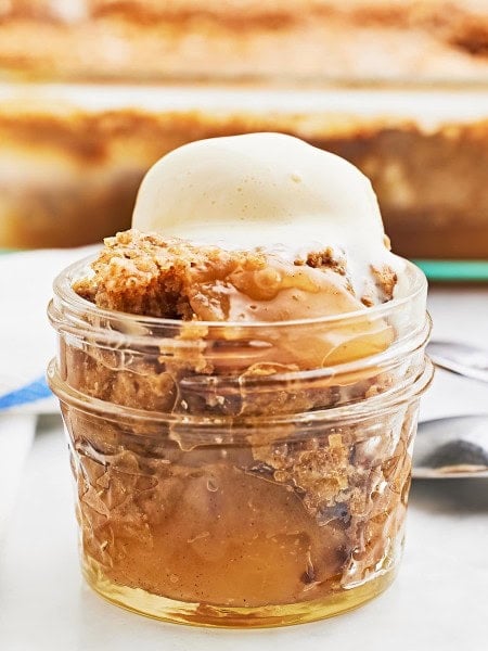 Closeup of an Apple Spice Dump Cake served with a scoop of vanilla ice cream.