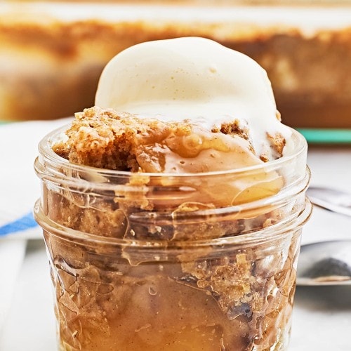 Closeup of an Apple Spice Dump Cake served with a scoop of vanilla ice cream.