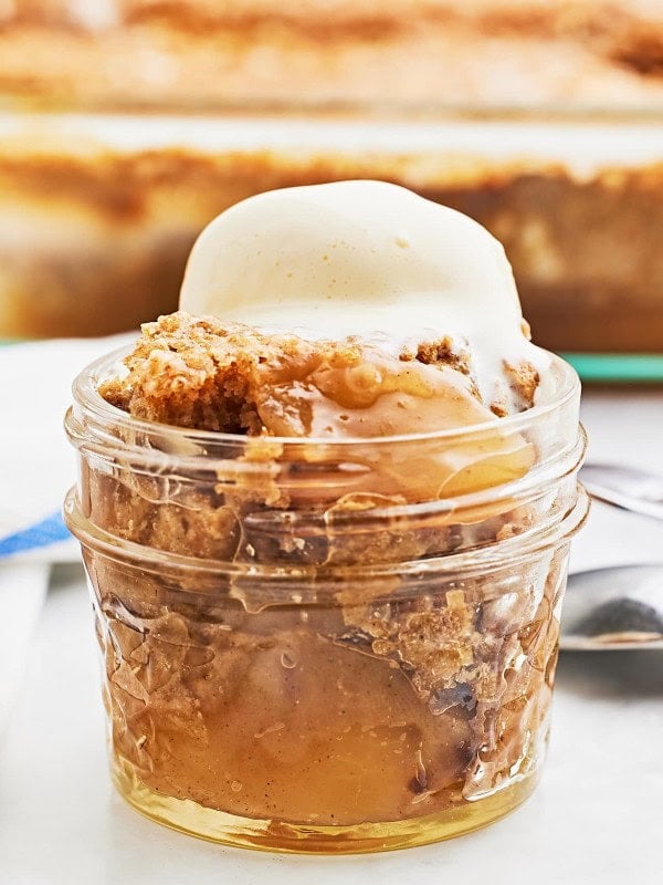 Closeup of an Apple Spice Dump Cake served with a scoop of vanilla ice cream.