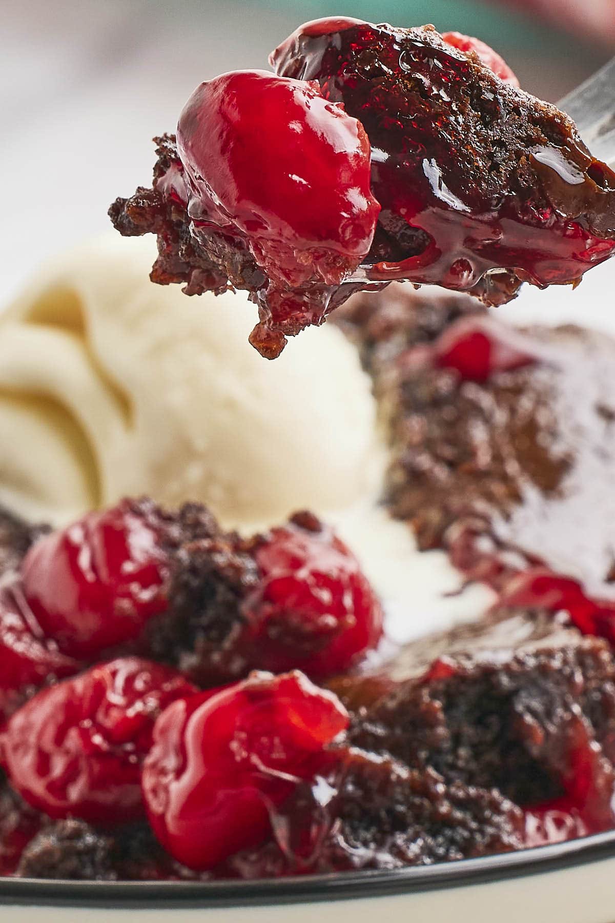 Closeup of a forkful of Black Forest Dump Cake.