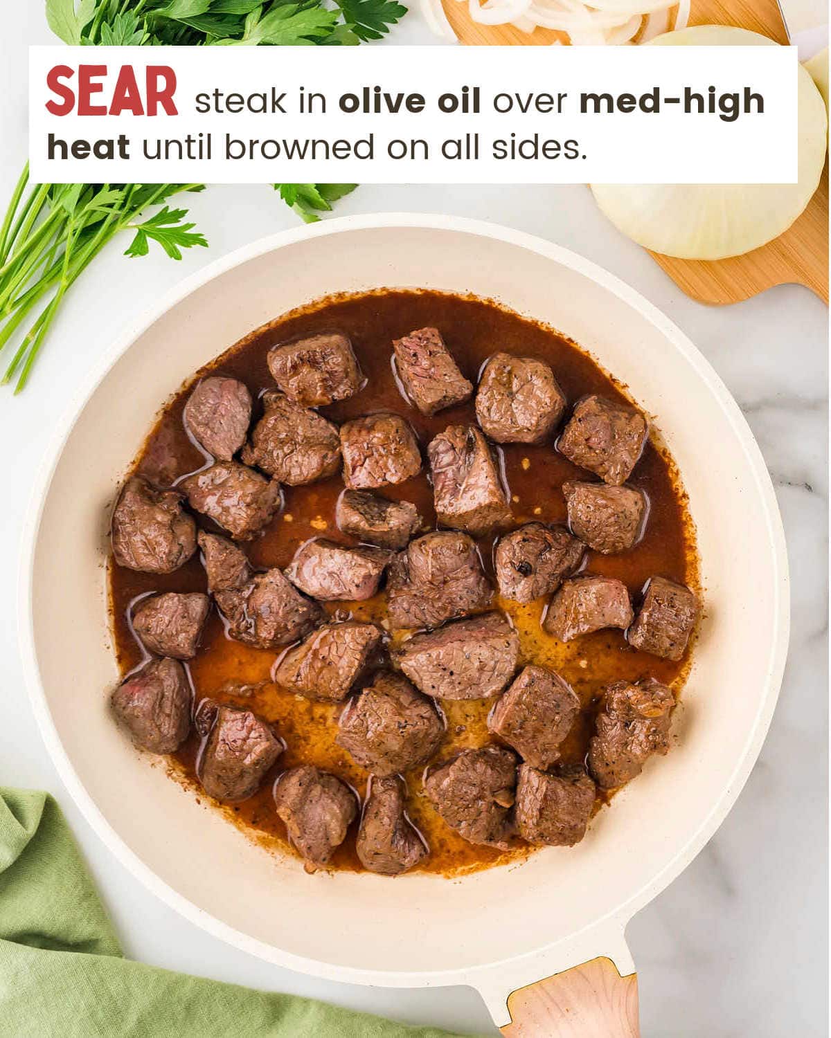 Searing sirloin in a skillet for Crock Pot Steak Bites.