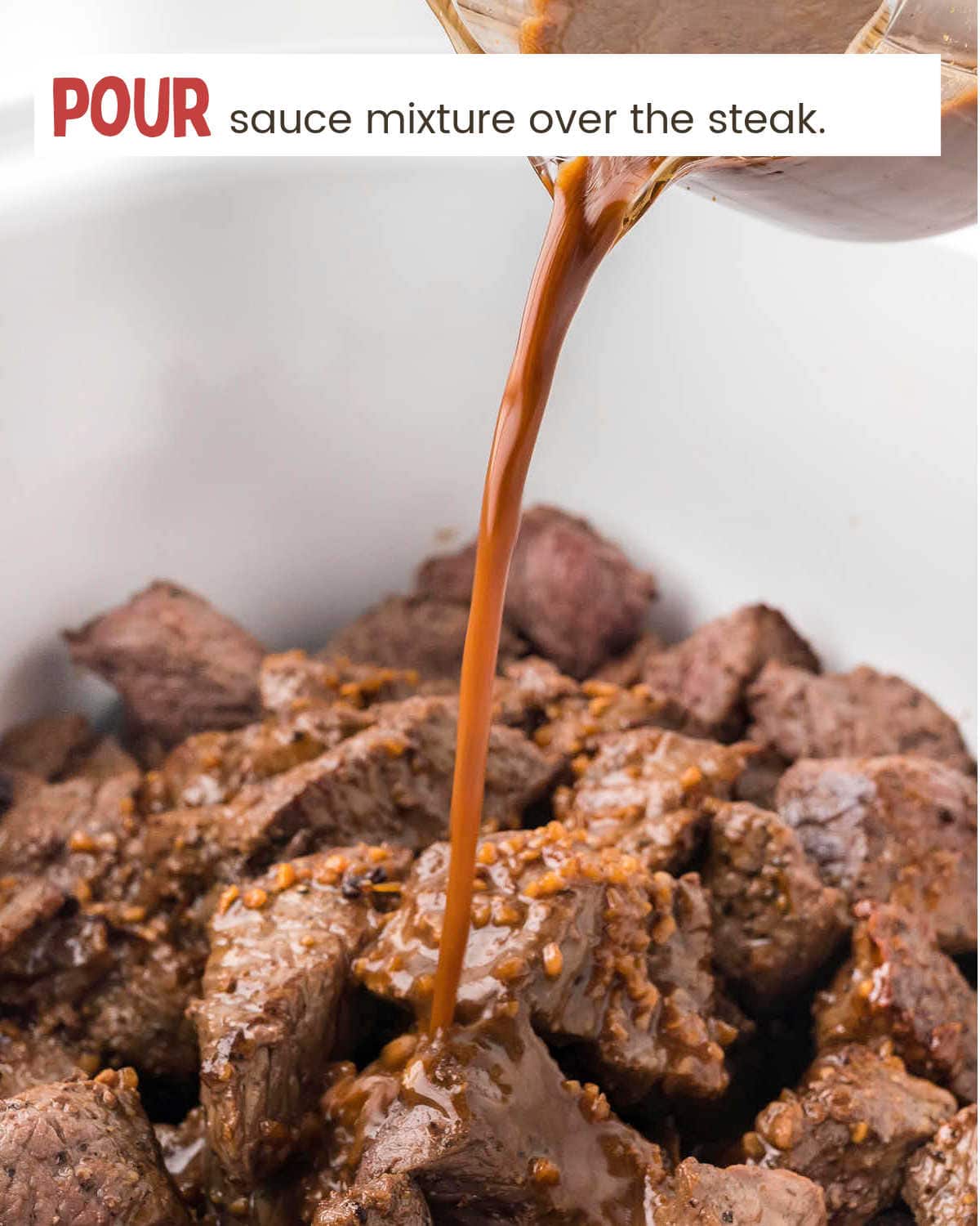 Pouring sauce over steak in slow cooker for Crock Pot Steak Bites.