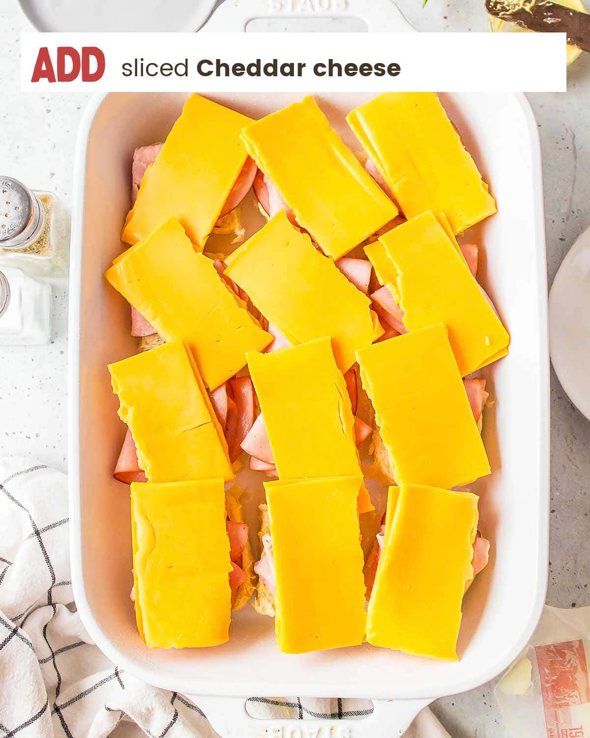 A dish with cheese and ham in it.