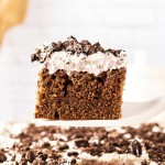 Slice of Oreo Sheet Cake on a white serving spatula.