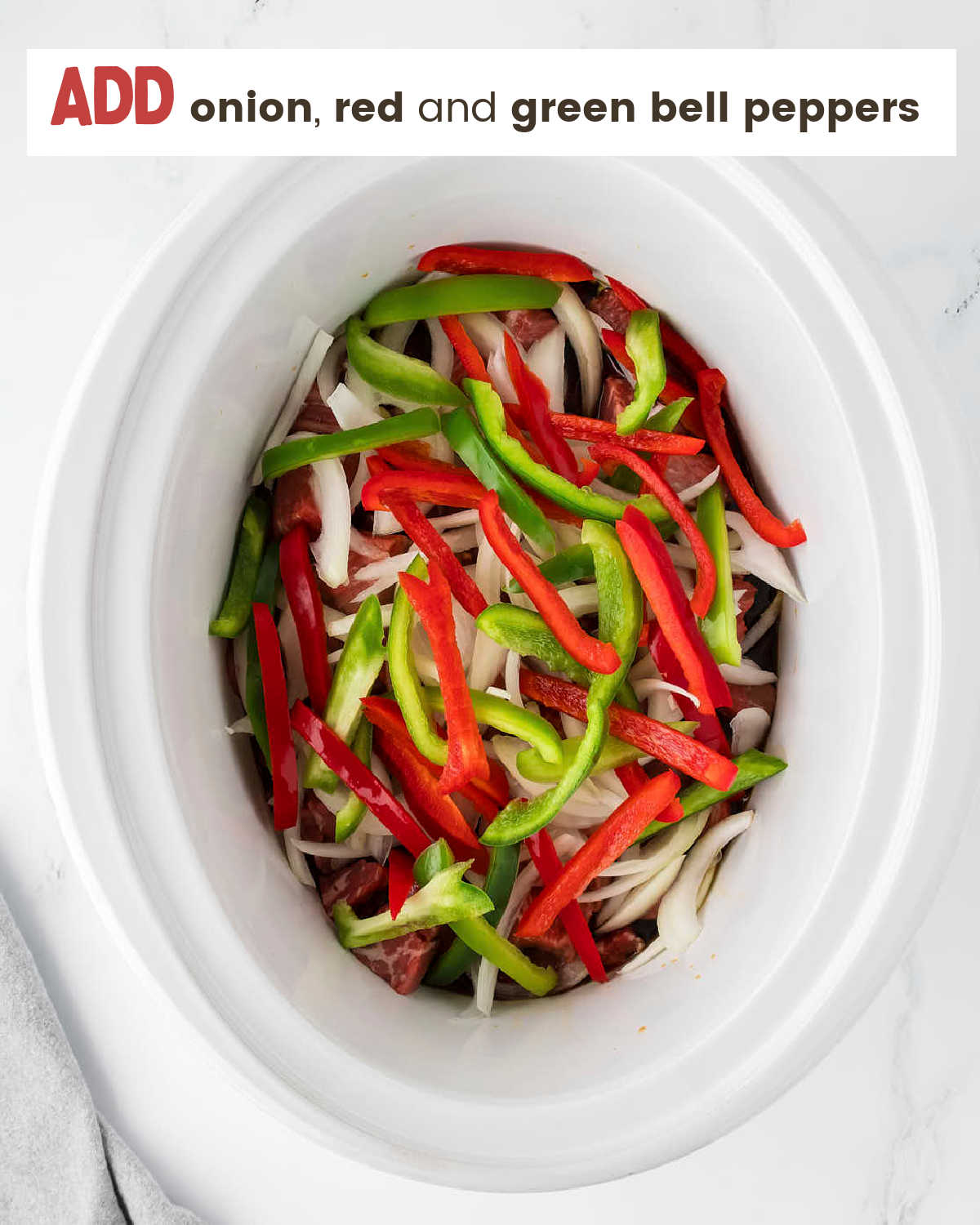 Add onion red and green bell peppers to slow cooker.