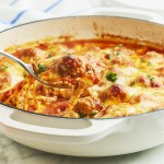 Cheesy Meatball Casserole in white cast iron dish.