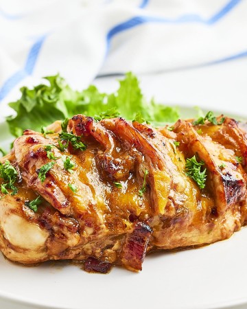 Hasselback chicken on a white plate.