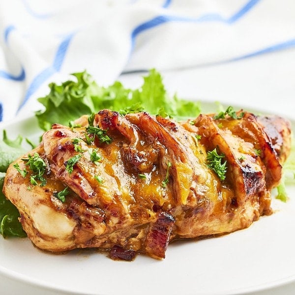 Hasselback chicken on a white plate.