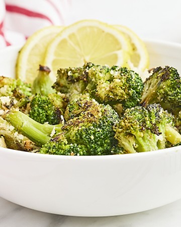 Closeup of Roasted Frozen Broccoli in a white bowl.