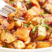 Closeup of a forkful of Roasted Potatoes and Carrots.