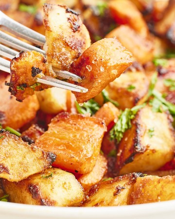 Closeup of a forkful of Roasted Potatoes and Carrots.