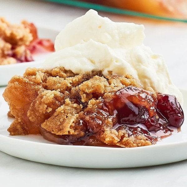 Closeup of a slice of Christmas Dump Cake on a white plate.
