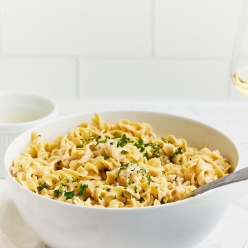 Freshly cooked French Onion Pasta in a large white serving bowl.