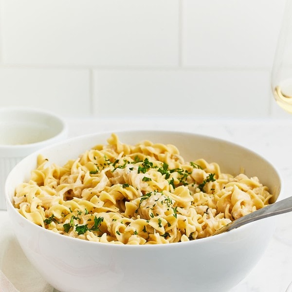 Freshly cooked French Onion Pasta in a large white serving bowl.