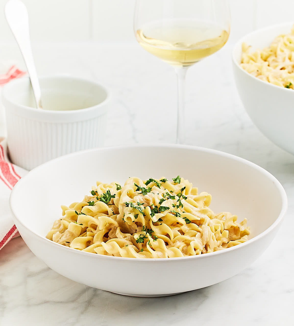 Freshly cooked French Onion Pasta in a white serving bowl.