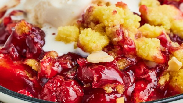 Cherry cobbler with ice cream and almonds.