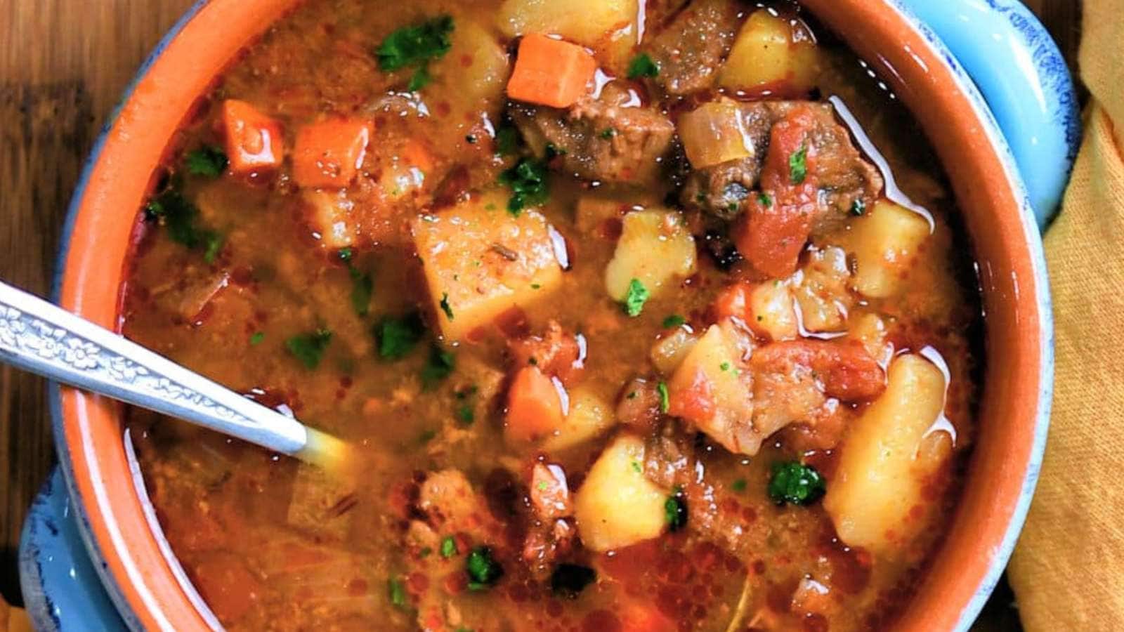 A bowl of stew with chorizo and venison.