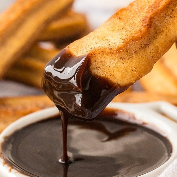 A baked Churro dipped in Chocolate.