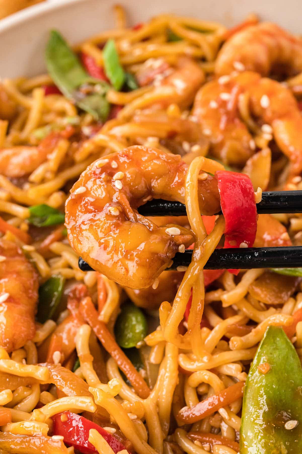 Close-up of Shrimp Lo Mein served with chopsticks.