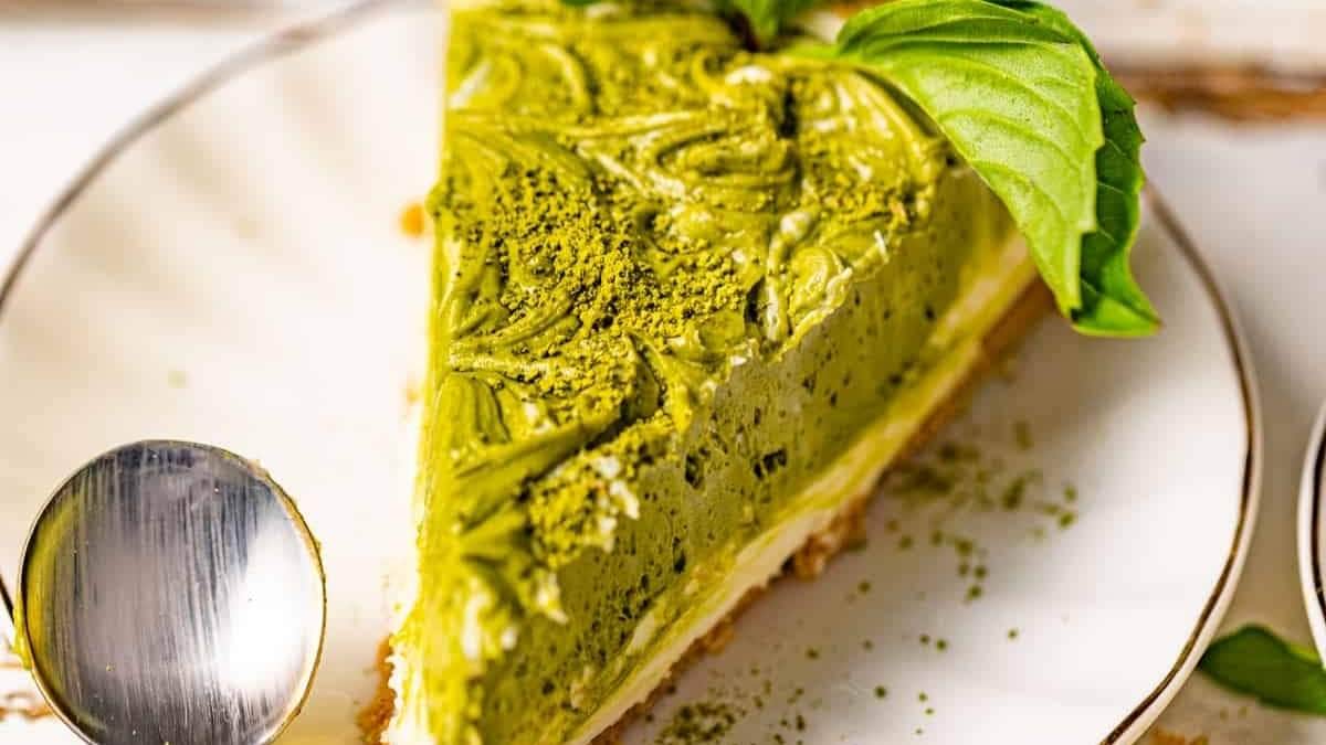 A decadent slice of matcha cheesecake, beautifully presented on a plate.