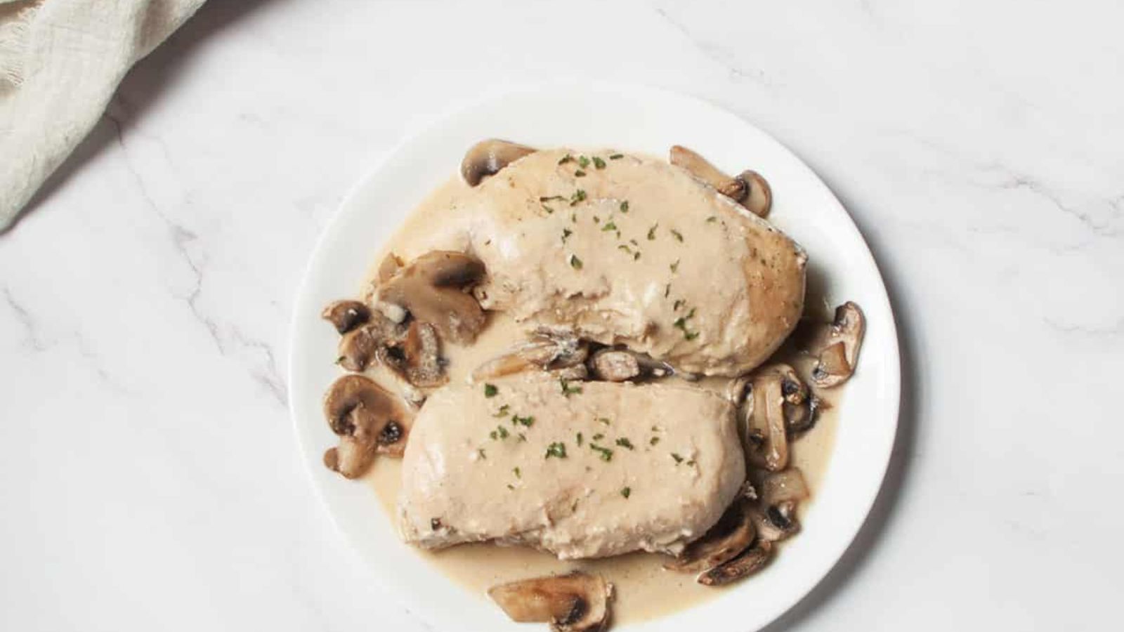 A plate of chicken breast with mushroom mustard sauce.