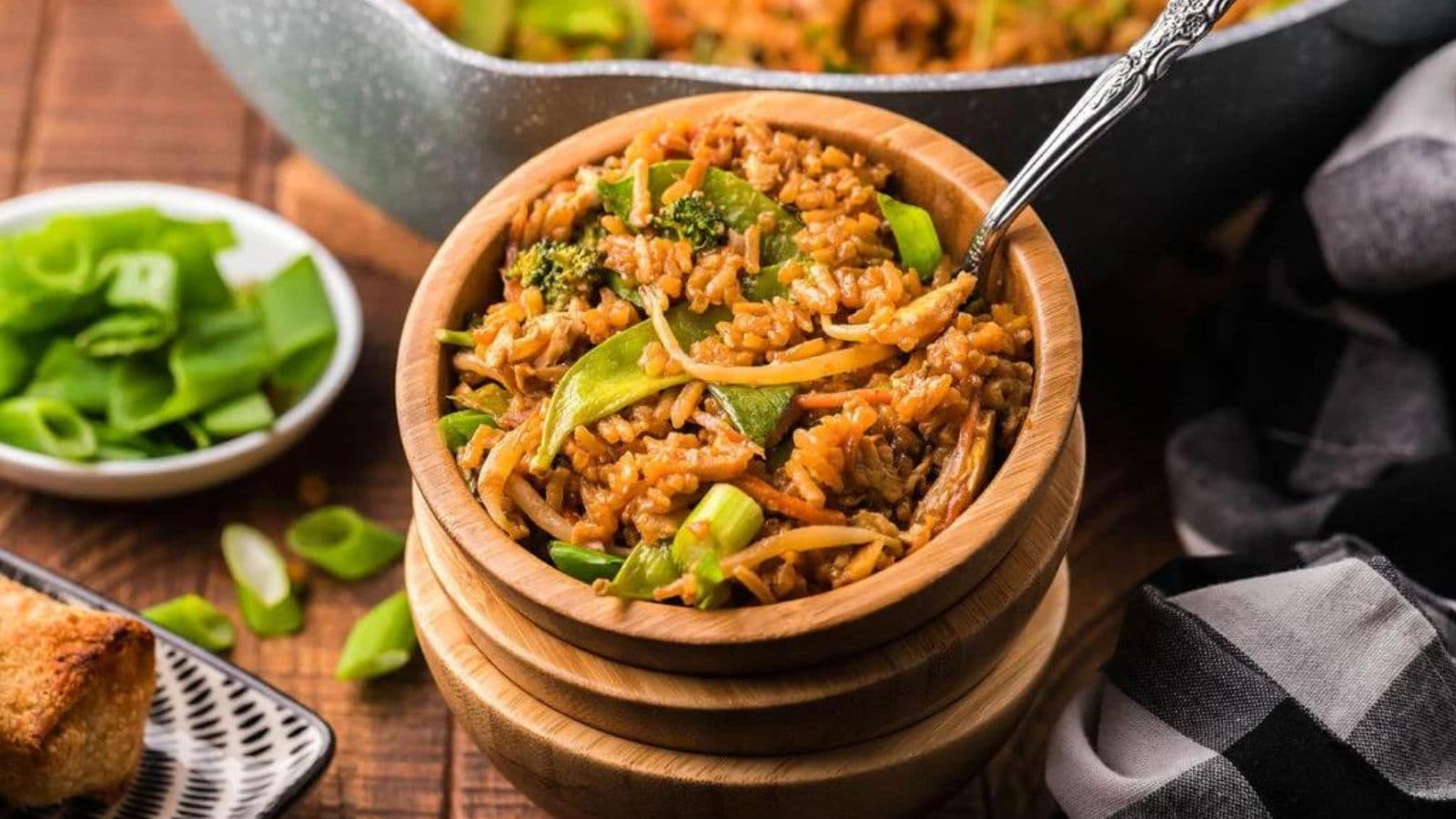 A bowl of fried rice with broccoli and snap peas.