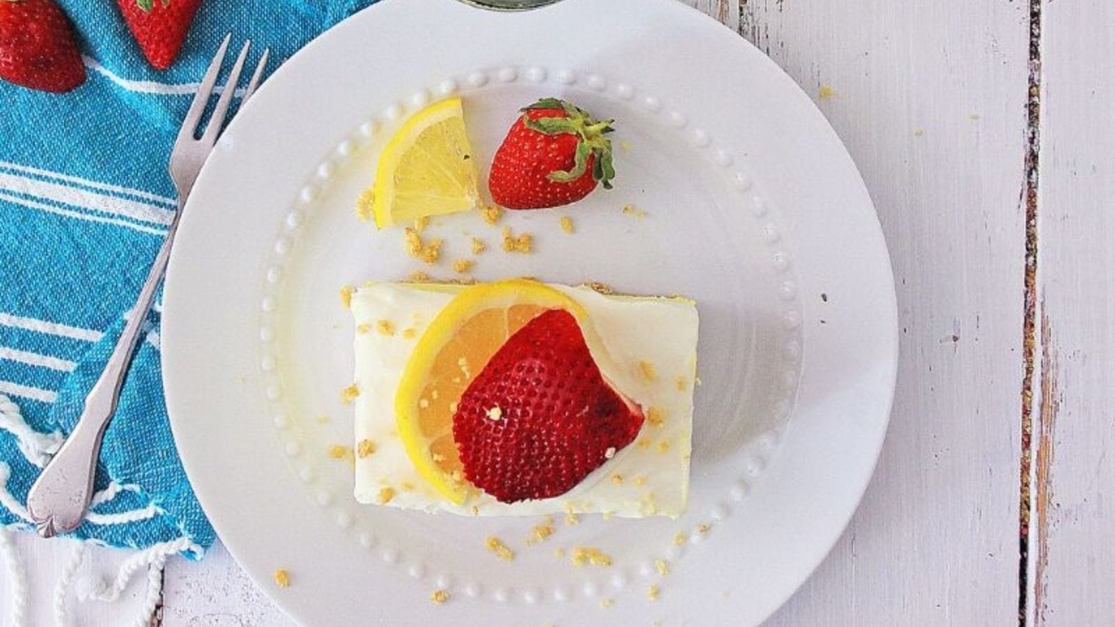 A no-bake cake with layers of lemon, strawberry, and pudding.