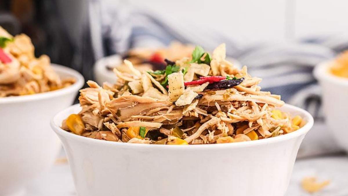 A bowl of chicken enchilada in a white bowl.
